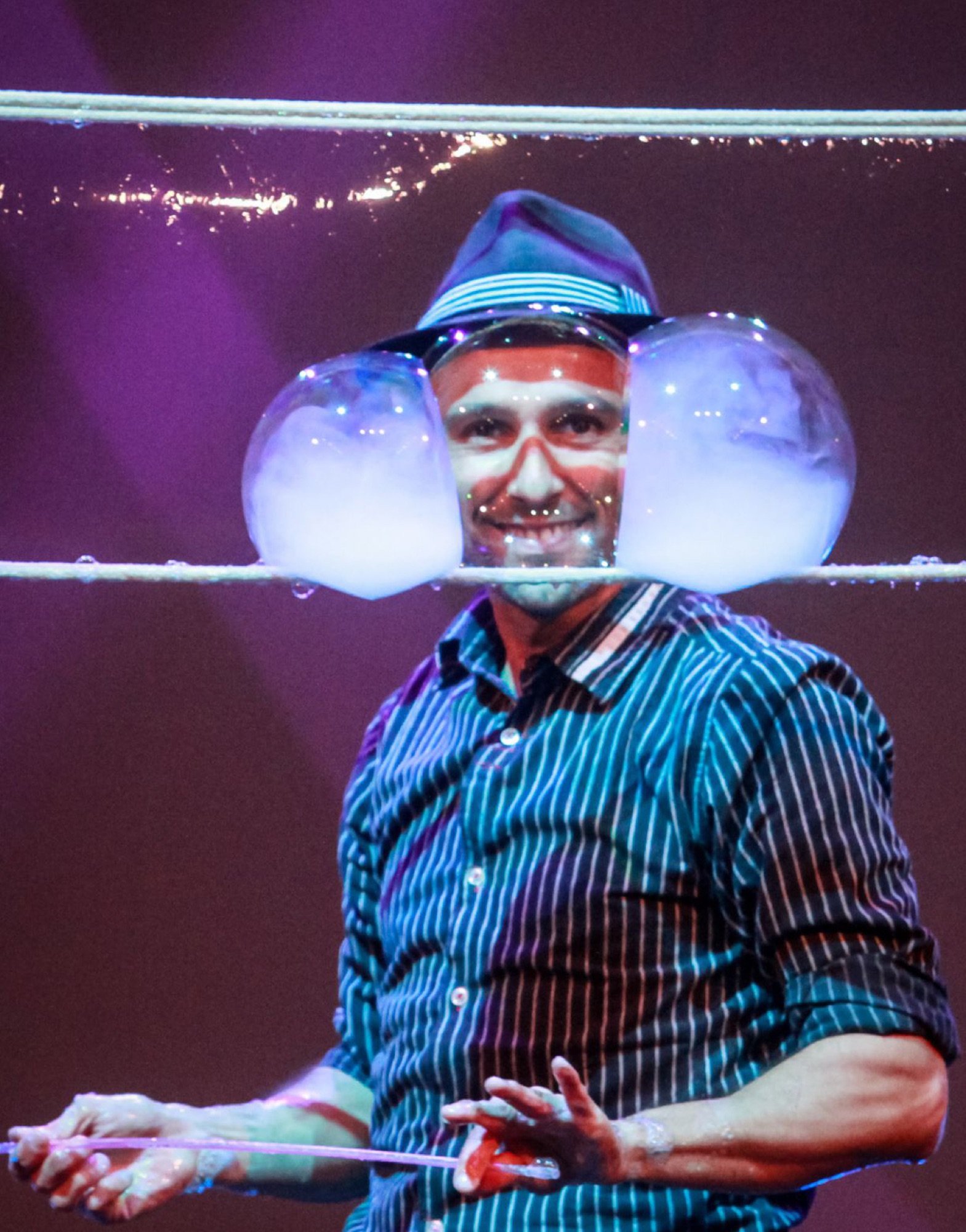 Smoke-filled bubble floating near a smiling face at a birthday celebration